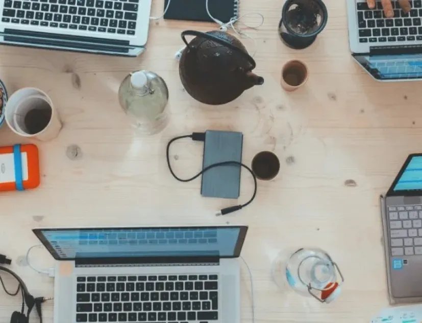 A bunch of laptops on a table from above